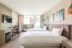 Postel nebo postele na pokoji v ubytování Hub Hotel Kaohsiung Yawan Branch