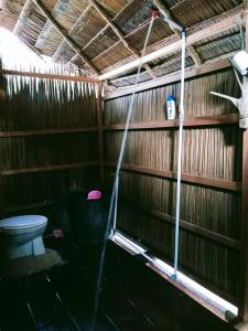 a shower in a bathroom with a toilet at Biryei Homestay in Pulau Birie