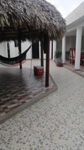 a resort with a hammock and a straw umbrella at Villa Myrian in Villanueva +16 photos