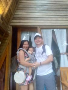 a man and a woman holding a baby at Kubu Penida Villa in Nusa Penida