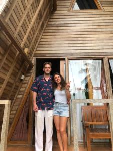 a man and a woman standing in front of a house at Kubu Penida Villa in Nusa Penida