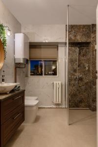 een badkamer met een douche, een toilet en een wastafel bij HOLT - Bagheera's Den in Boekarest