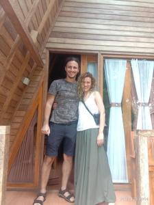 a man and a woman standing in front of a house at Kubu Penida Villa in Nusa Penida