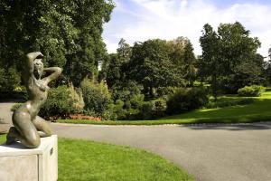a statue of a woman sitting on the grass at Mercure Angers Centre de Congrès in Angers