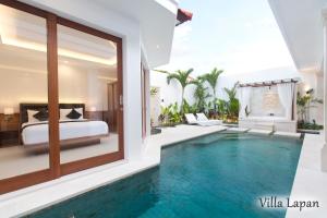 a villa with a swimming pool in a bedroom at Villa Mia Seminyak - Boutique Villas in Seminyak