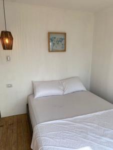 a bedroom with two beds and a picture on the wall at SUNSET BEACH in Playa Blanca