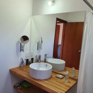 baño con lavabo y espejo grande en Sierra y Sol, en Villa Serrana