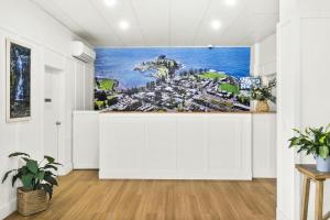 a living room with a wall mural of a city at Kiama Shores in Kiama