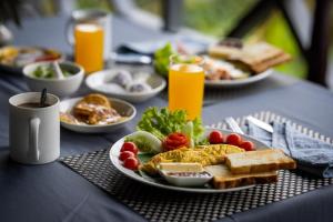 a table with plates of food on a table at Resort Maison de Nongkhiaw in Nongkhiaw