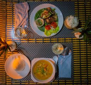 a table with two plates of food and a bowl of soup at Resort Maison de Nongkhiaw in Nongkhiaw +36 photos