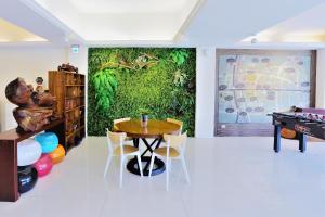 a dining room with a table and a wall mural at Huang Shin Business Hotel-Chung Kang in Taichung