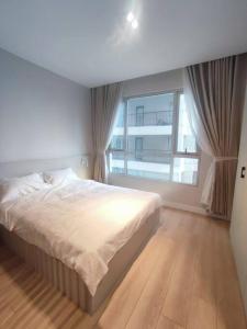 une chambre avec un lit et une grande fenêtre dans l'établissement The Rixx Business Apartment @D1/Netflix/sauna/gym, à Hô-Chi-Minh-Ville