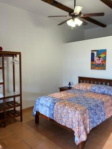 una camera con letto e ventilatore a soffitto di La Casa de Cafe Bed and Breakfast a Rovine di Copán