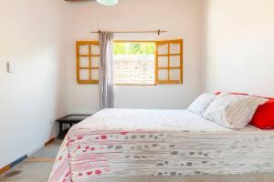 a bedroom with a large bed with a window at Las Juanas in Eugenio Bustos