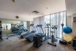 a gym with several treadmills and elliptical machines at Park view Avalon Apartment District 1 HCM City in Ho Chi Minh City