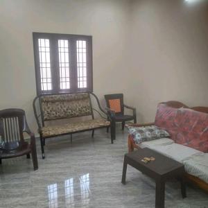 a living room with chairs and a couch and a table at ARS furnished house in Chrompet