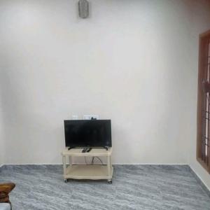 a flat screen tv sitting on a table in a room at ARS furnished house in Chromepet