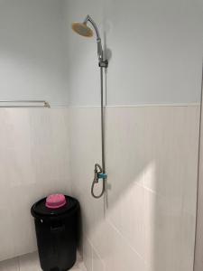 a shower stall with a black trash can in a bathroom at Phangan Dream box in Baan Tai