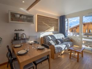 a living room with a table and a couch at Appartement Val Thorens, 2 pièces, 4 personnes - FR-1-640-10 in Val Thorens