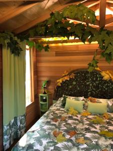 a bedroom with a bed with leaves on it at Lake Como Dream Tree House in Como