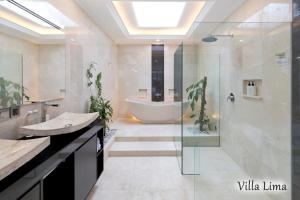 a bathroom with a tub and a sink and a shower at Villa Mia Seminyak - Boutique Villas in Seminyak