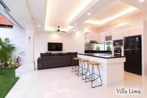 a kitchen and living room with a couch and a counter at Villa Mia Seminyak - Boutique Villas in Seminyak