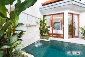 a swimming pool in a villa with plants at Villa Mia Seminyak - Boutique Villas in Seminyak