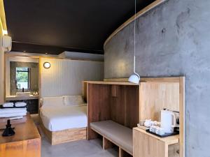 a bedroom with a bed and a desk with a tv at Delight Inn in Yanqing