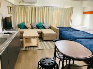 um pequeno quarto com uma cama e um sofá em 板橋 RCアネックス Rc206 em Tóquio