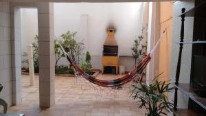 a room with a hammock in the middle of a building at Hotel Pousada Perdizes in São Paulo