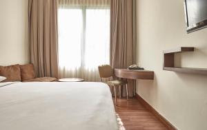 Postel nebo postele na pokoji v ubytování Grand Cikarang Hotel
