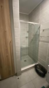 a shower with a glass door in a bathroom at BALLITO HILLS, 1 bedroom apartment in Ballito