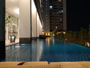 a large swimming pool in a building at night at Apartment Breeze Bintaro, Tangerang Selatan in Pondoklang