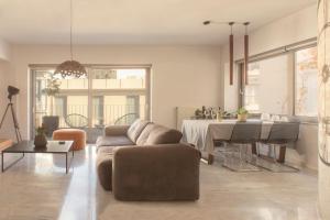 a living room with a couch and a table at Luxury Apt with Parking-Living Stone Silver in Athens