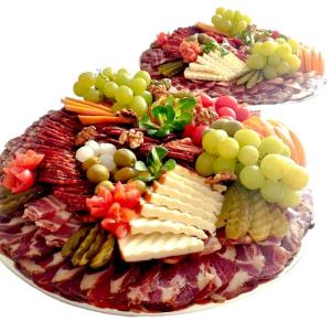 a plate of cheese and crackers and fruits and vegetables at Kuća za odmor/Party kuća in Lukinić Senovec
