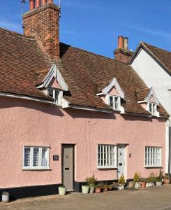 a pink house with a brown roof at Almond Cottage Clare - 2 bedroom English Cottage in Clare