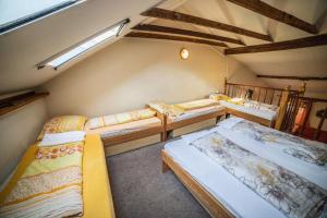 a group of four beds in a room at Vinný Sklep U Terezy a Jakuba in Moravská Nová Ves