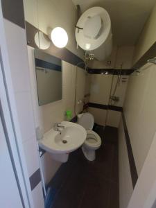 a small bathroom with a toilet and a sink at Studios & Apartments Perla in Sunny Beach