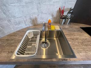 a stainless steel sink in a counter top at Wolf Pack Apartment 1001 in Osaka