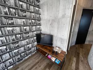 a room with a wall full of books at Wolf Pack Apartment 1001 in Osaka