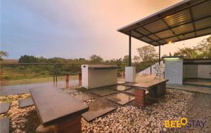 a patio with a picnic table and a pavilion at Cheng Landed Villa in Taman Bertam Setia Melaka in Malacca