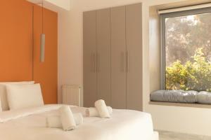 a bedroom with two white beds and a window at Luxury Apt with Parking-Living Stone Silver in Athens