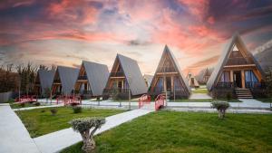 a large building with triangular roofs on a lawn at Reserve Resort Lagodekhi in Lagodekhi