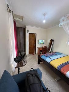 Postel nebo postele na pokoji v ubytování Pearl suites - Bukoto