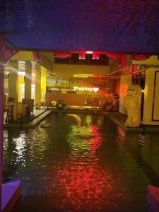 a pool of water with red lights in a building at AURA HOTEL in Angeles