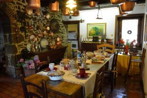 a dining room with a table with food on it at Agriturismo Casa di Campagna in Miane