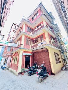 a couple of motorcycles parked in front of a building at Hotel Green Orchid in Kathmandu