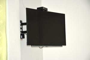 a flat screen tv hanging on a wall at Paramata Hotel Pallekele in Pallekele Kadawidiya