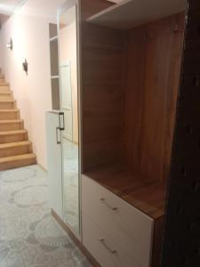 a closet with a glass door in a room at 2-storey apartment in Mardakan