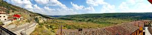 a view of a valley from a hill with houses at Alojamientos Carmen in Beteta